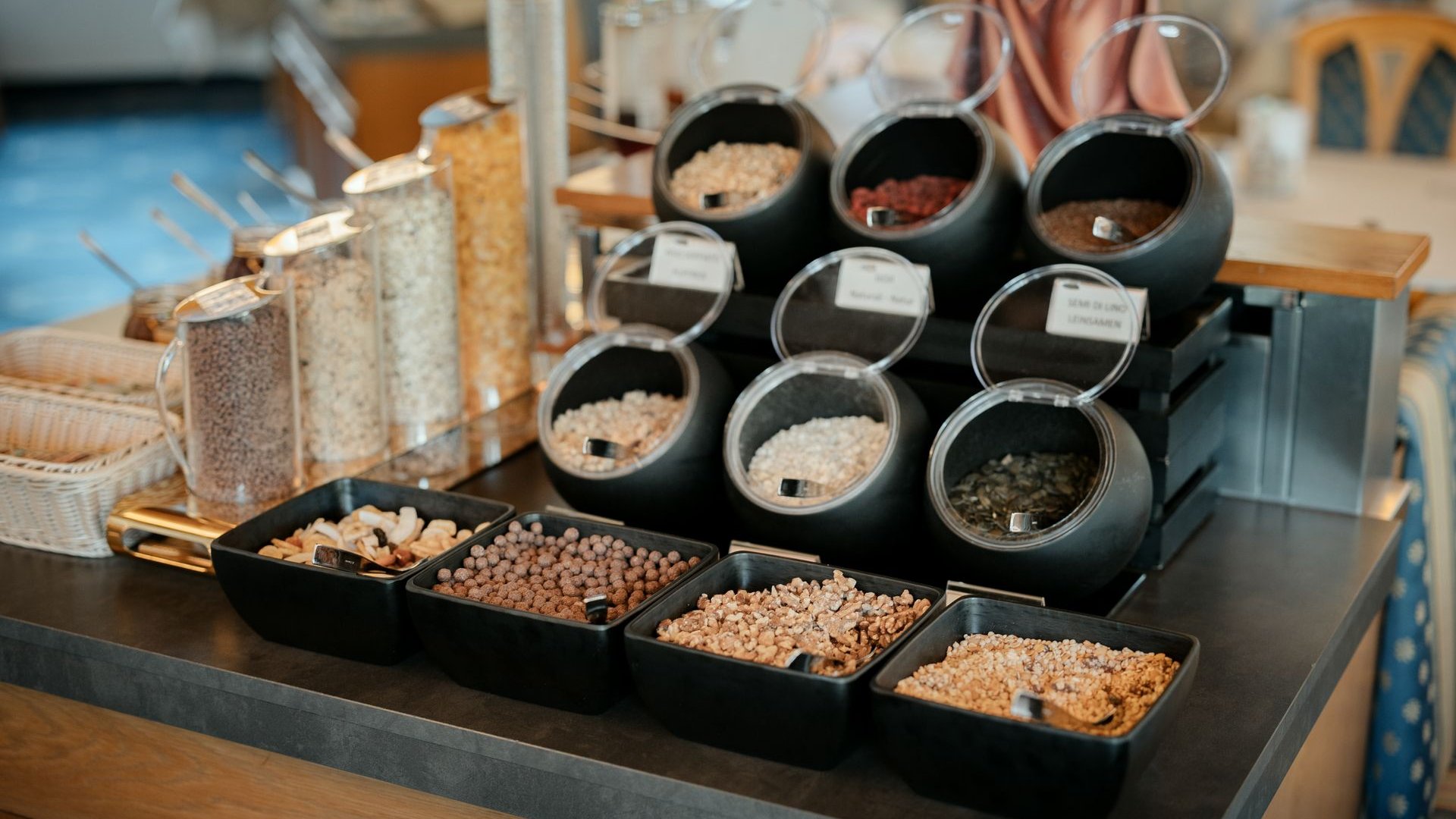 Il nostro hotel a 3 stelle in Val Gardena e la sua cucina Varie noci e semi in contenitori su un bancone buffet